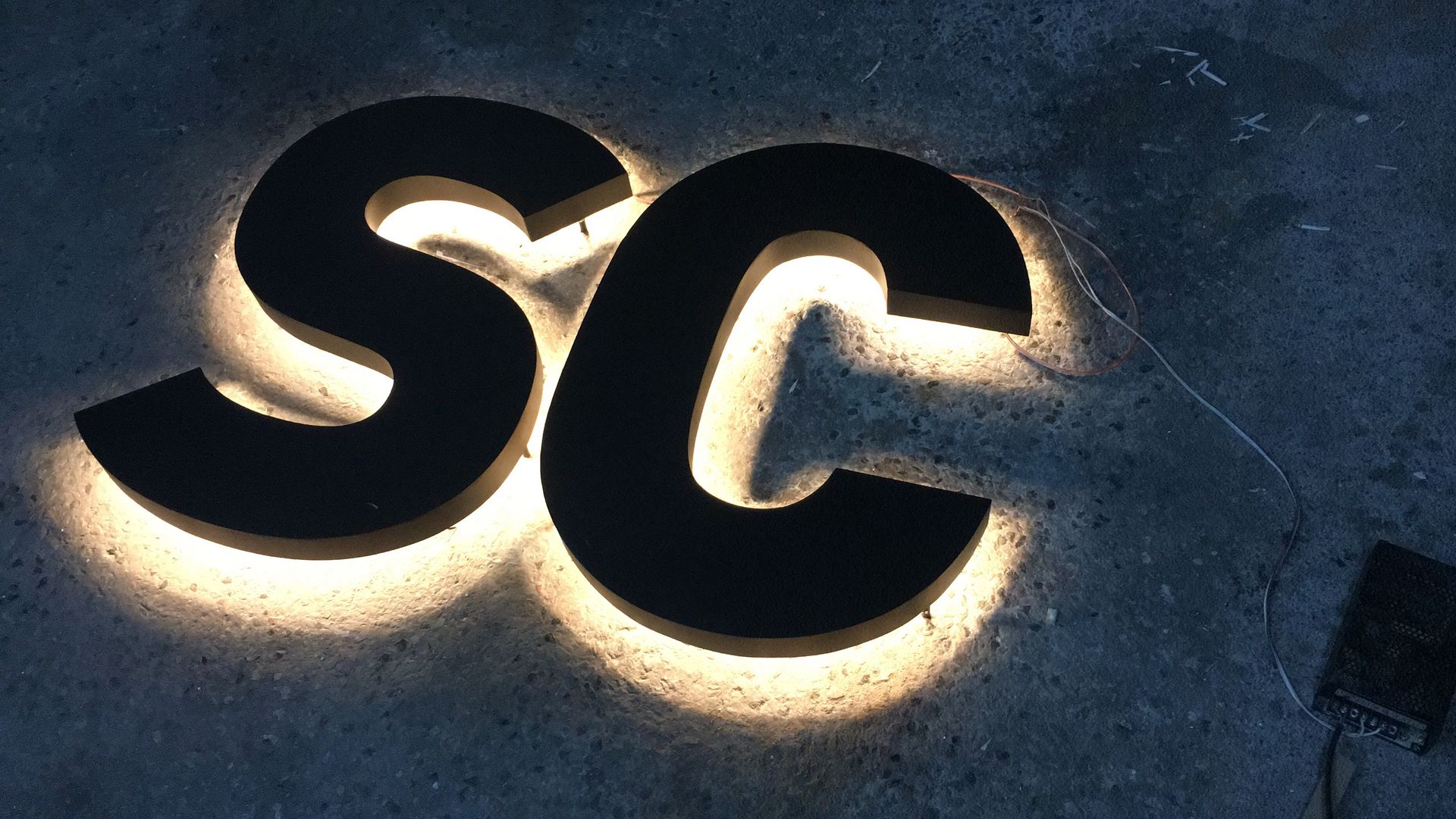 Halo-lit letters glowing on concrete