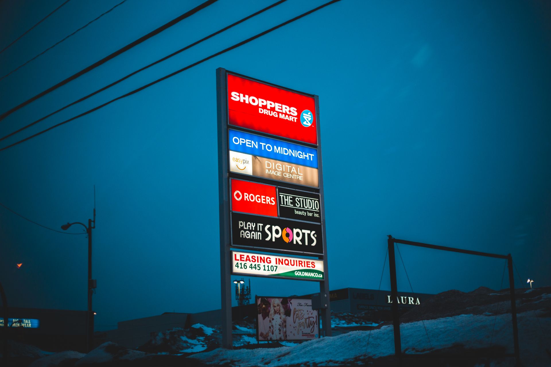 Tall board with the signs of several shops