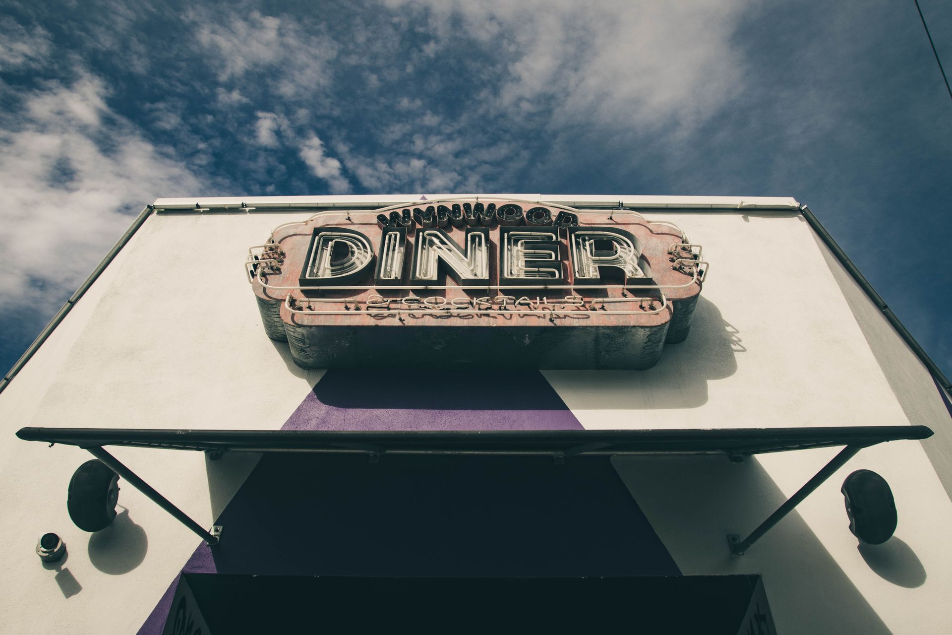 Vintage diner sign against a blue sky