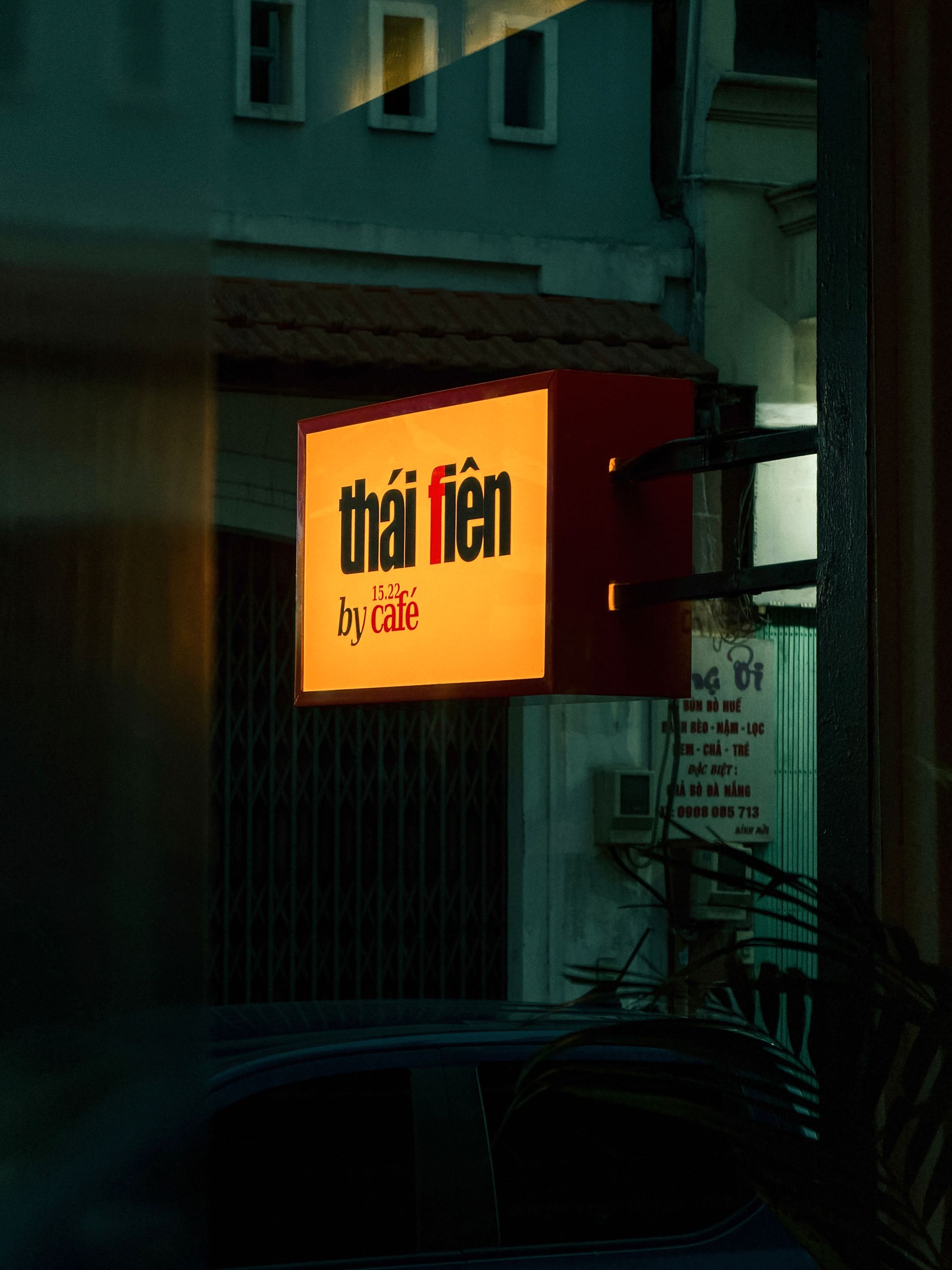 Café sign with lit lettering at night