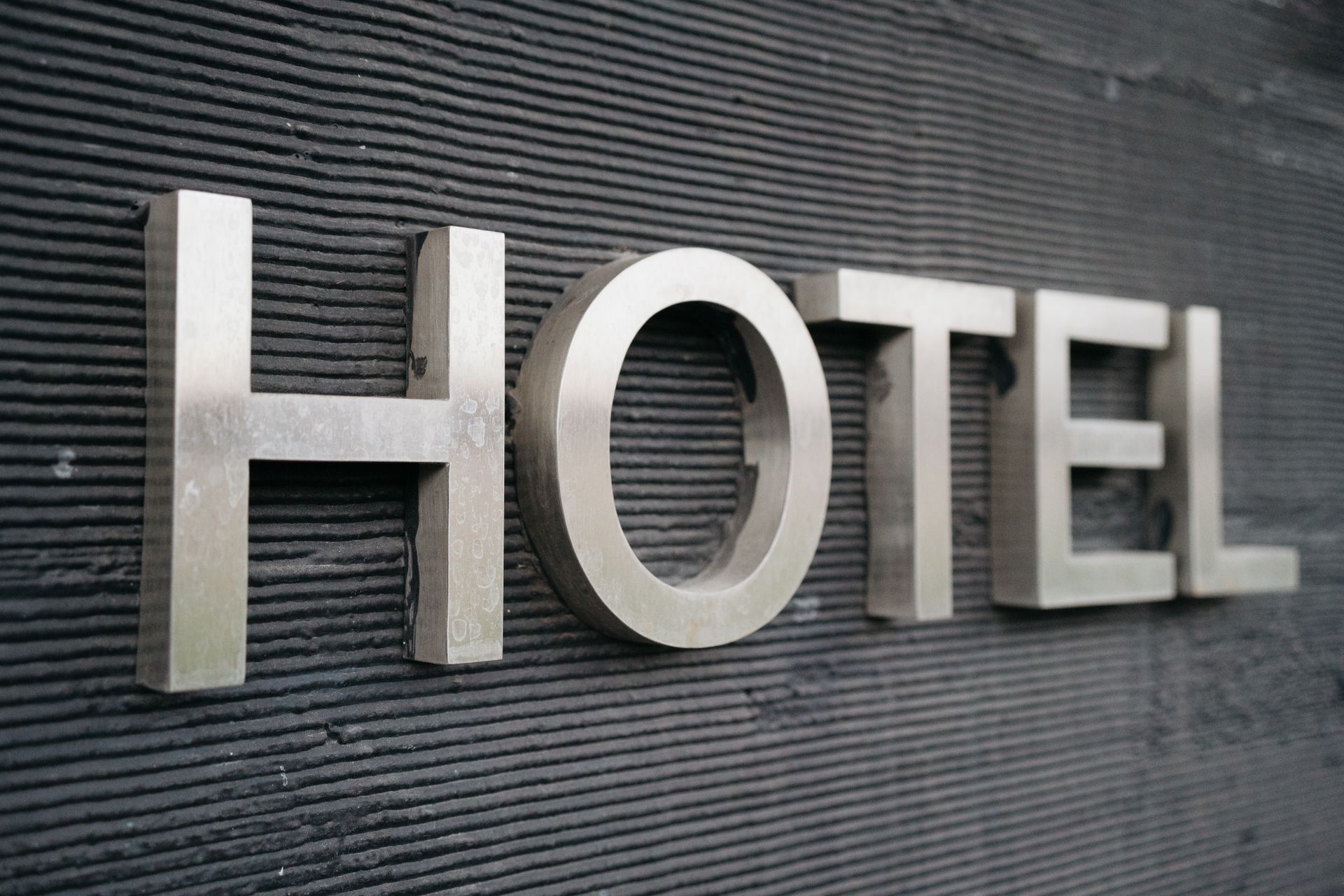 Brushed metal sign on a textured wall