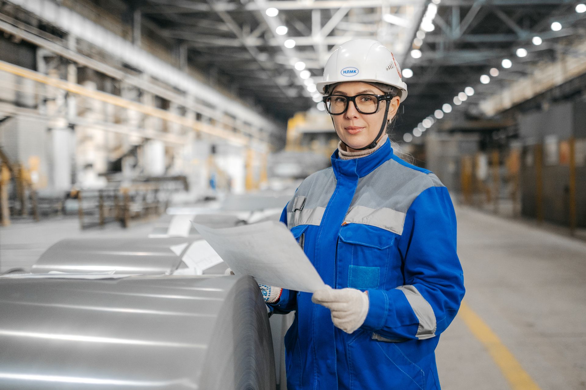 Engineer in safety gear inspecting equipment