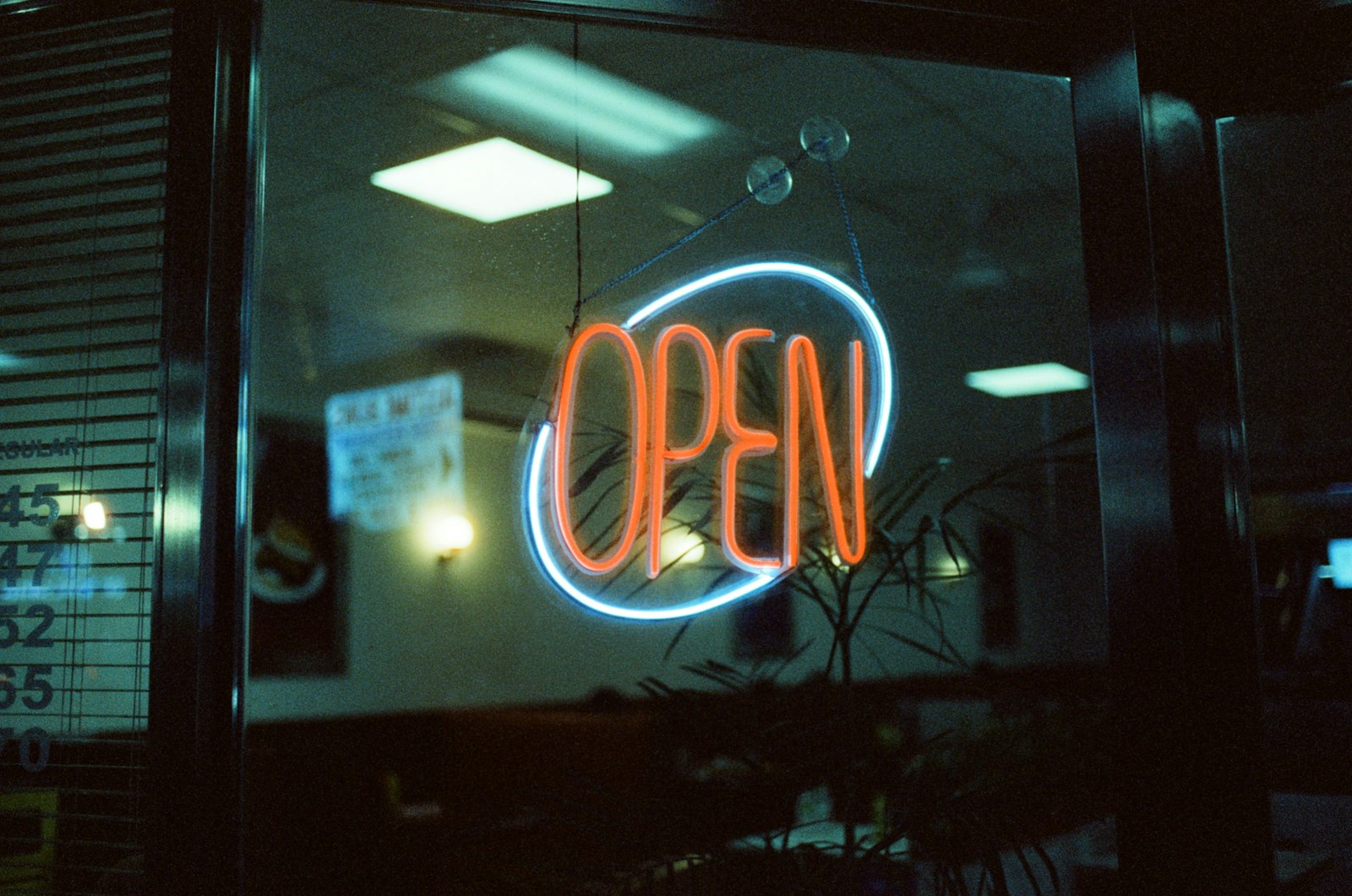 Open neon sign in a storefront window